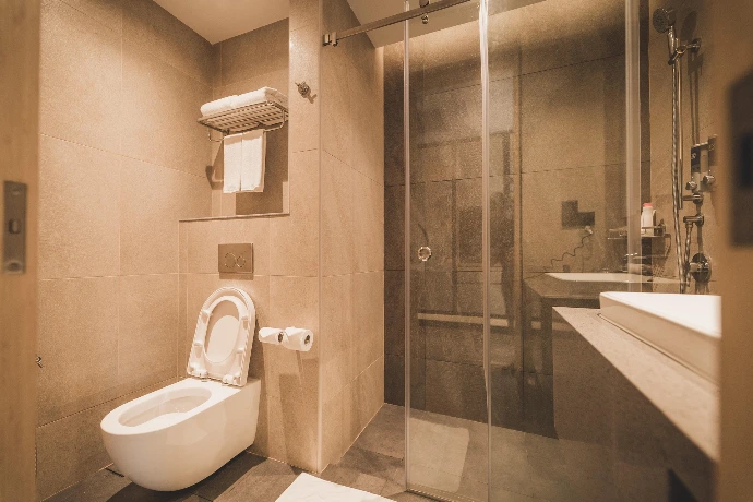 A modern bathroom with a glass shower enclosure 