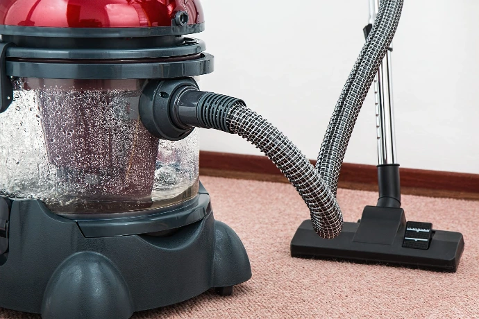 A vacuum cleaner hose and nozzle